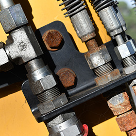 close-up of industrial hydraulic fittings showing rusted and clean sections five essential components for machinery maintenance