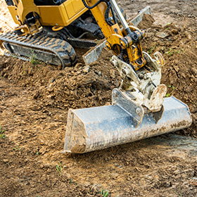 yellow excavator digging in dirt six construction projects