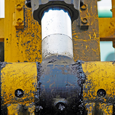 close up of a metal joint on industrial machinery with yellow and black details showcasing oil and wear typical of construction and engineering applications relevant to seven effective systems