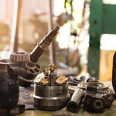 various mechanical tools and parts arranged on a workbench including fuel injectors and components related to engine repair and maintenance for two vehicles