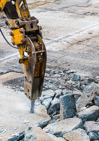 heavy machinery breaking concrete rubble at a construction site 8 tools for demolition