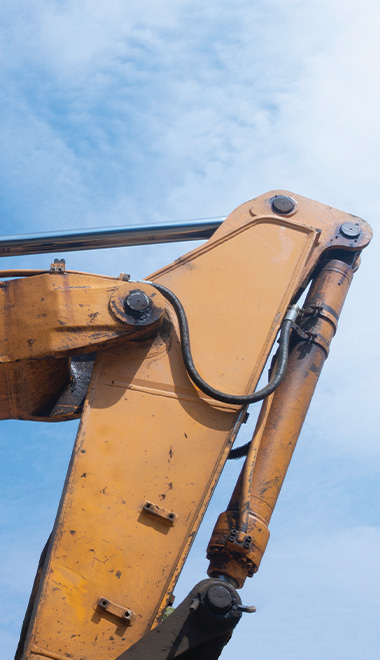 yellow excavator arm against blue sky showing hydraulic components construction machinery 1